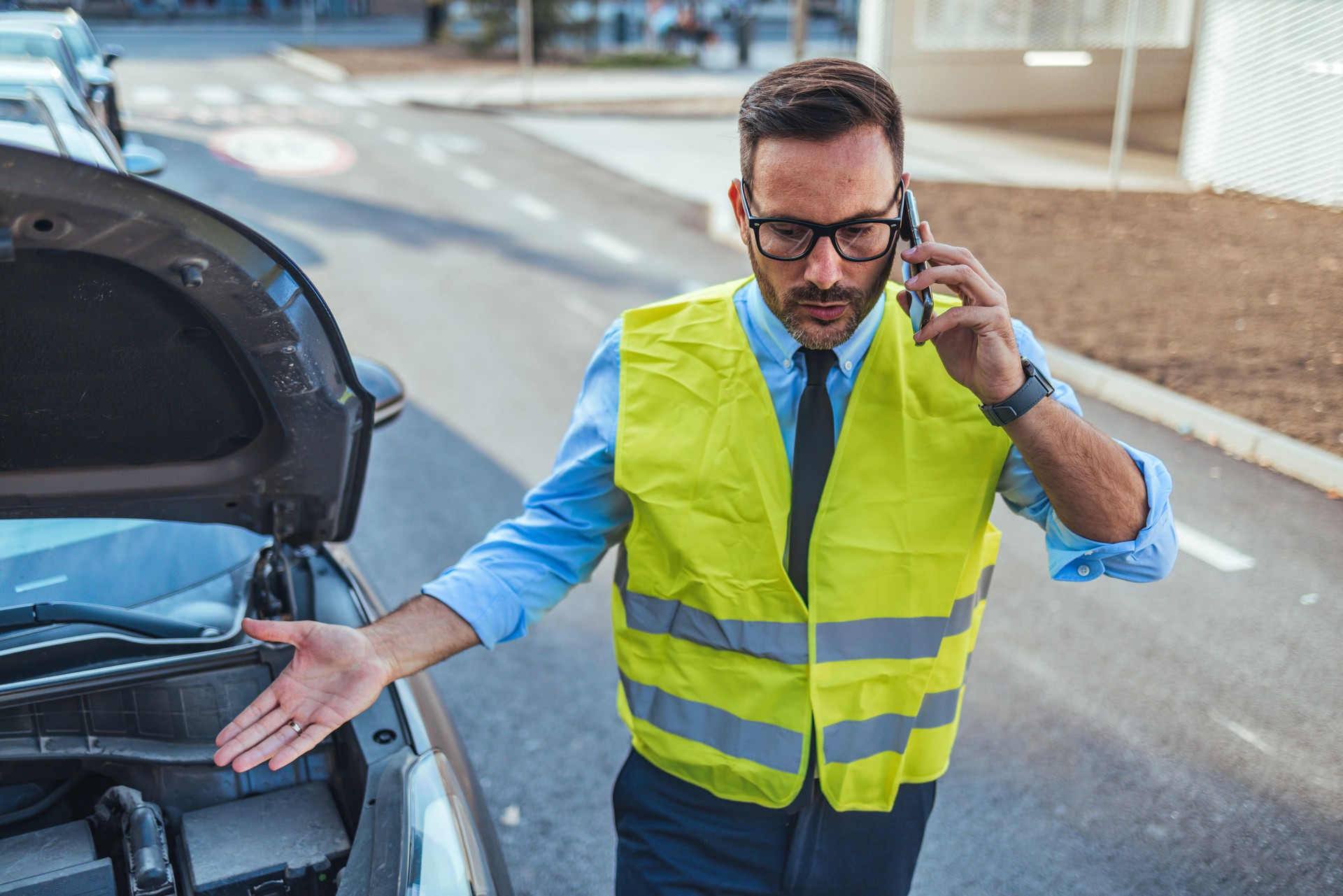 Man in Safety Vest Calling for Roadside Assistance